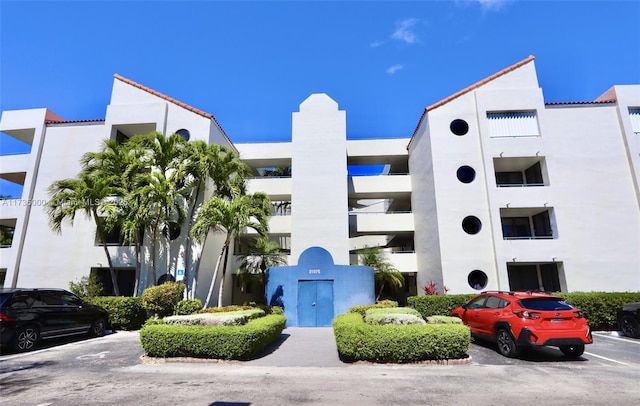 view of building exterior with uncovered parking