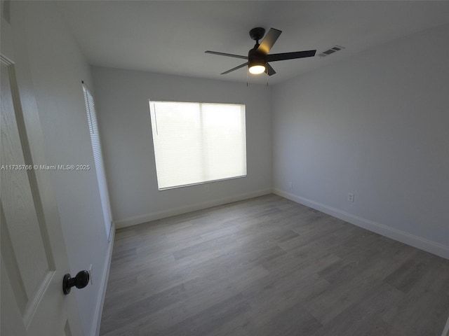 unfurnished room featuring hardwood / wood-style flooring and ceiling fan