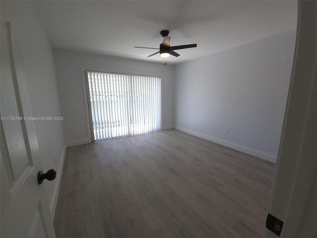 empty room featuring ceiling fan and hardwood / wood-style floors