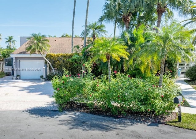 obstructed view of property with a garage