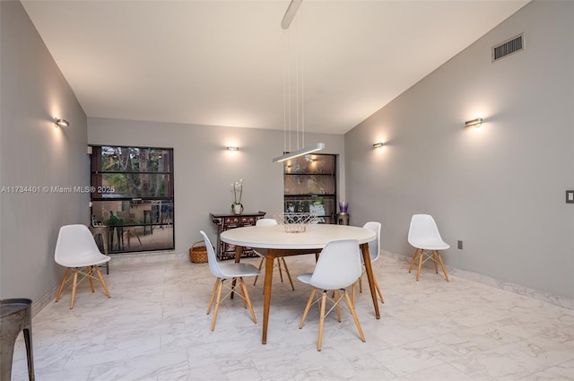 dining room with vaulted ceiling