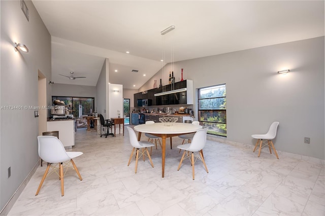 dining space featuring lofted ceiling