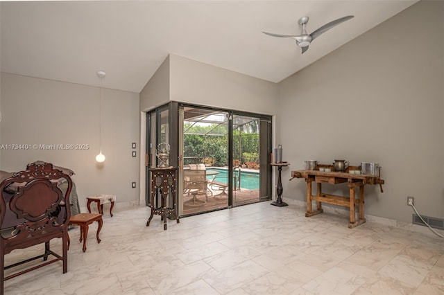 interior space featuring high vaulted ceiling and ceiling fan