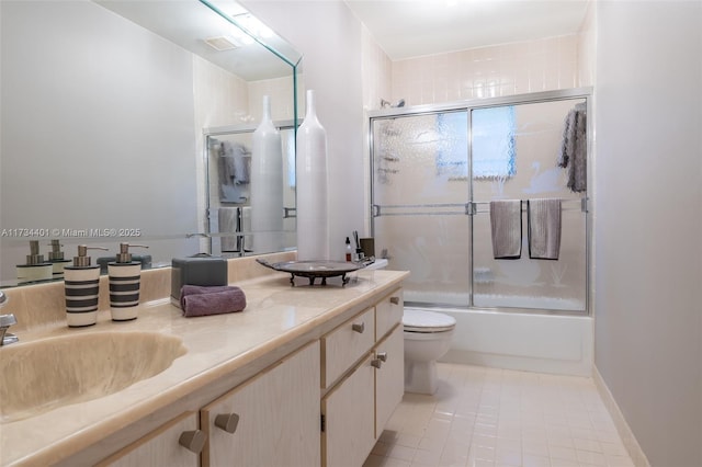 full bathroom featuring vanity, tile patterned floors, toilet, and combined bath / shower with glass door