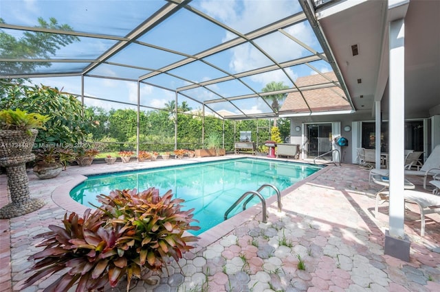 view of swimming pool with a patio and a lanai