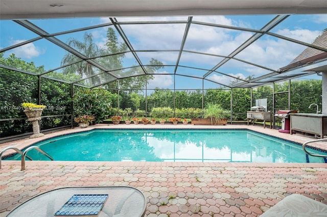 view of swimming pool featuring a lanai and a patio area