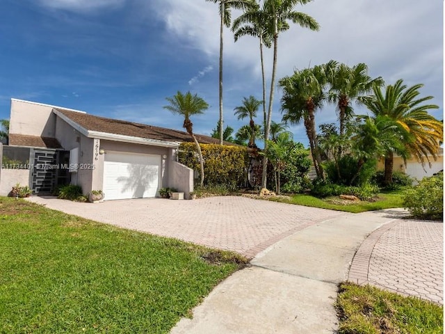 view of side of home featuring a garage and a yard