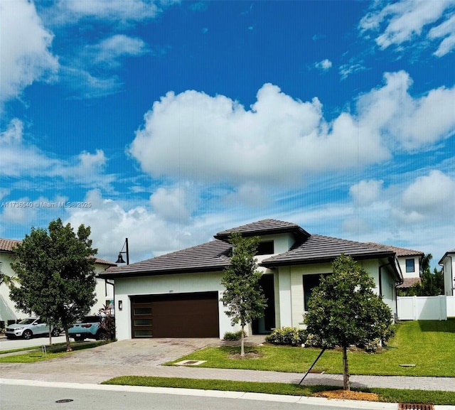 view of front of property featuring a garage and a front yard