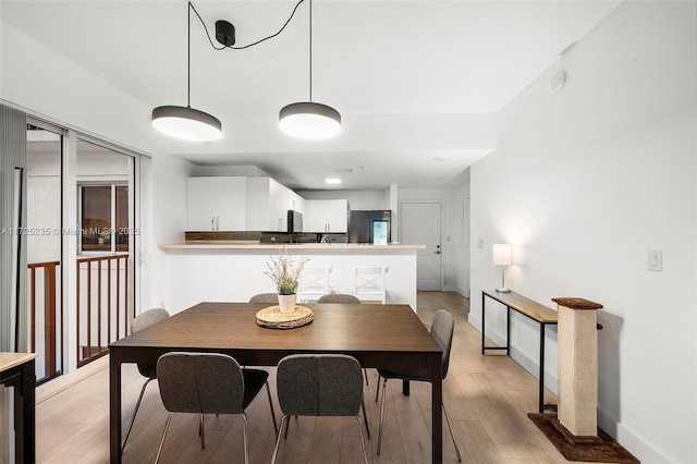 dining area with light hardwood / wood-style flooring