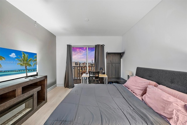 bedroom featuring access to exterior and light hardwood / wood-style floors