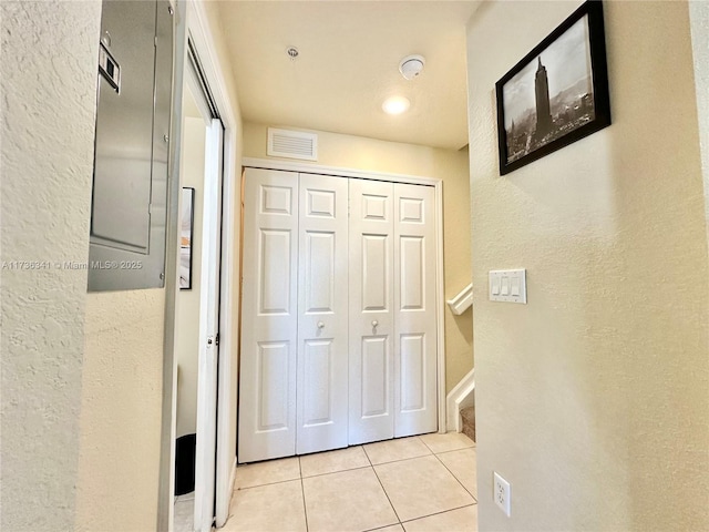 corridor with light tile patterned floors