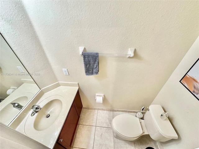 bathroom with vanity, tile patterned floors, and toilet