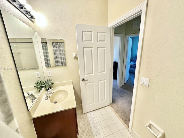 bathroom featuring tile patterned flooring and vanity