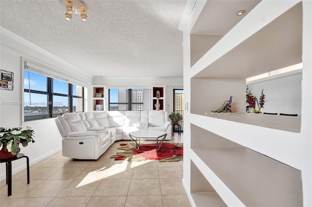 tiled living room featuring ornamental molding, a textured ceiling, and baseboards