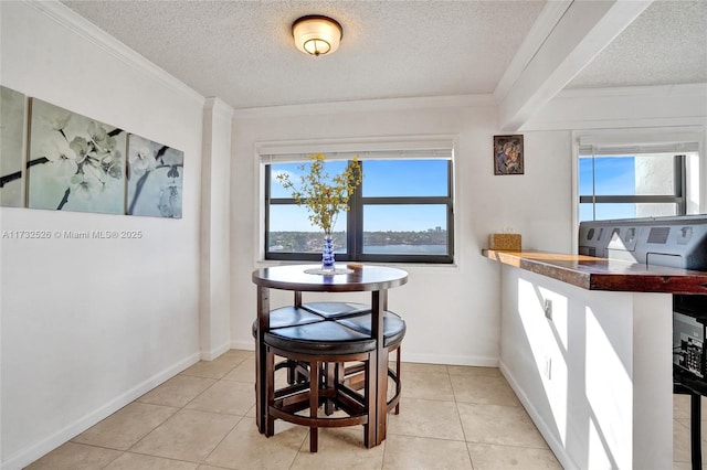 dining room featuring a textured ceiling and light tile patterned floors