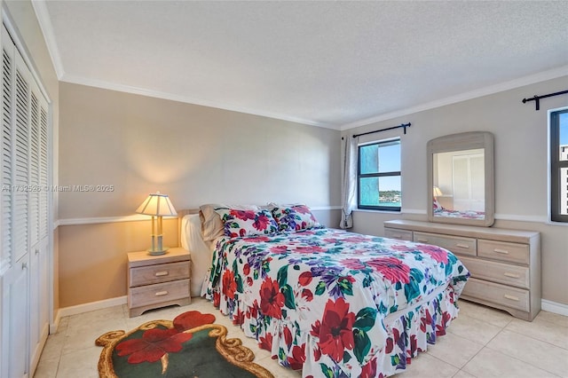 bedroom with a textured ceiling, baseboards, and crown molding