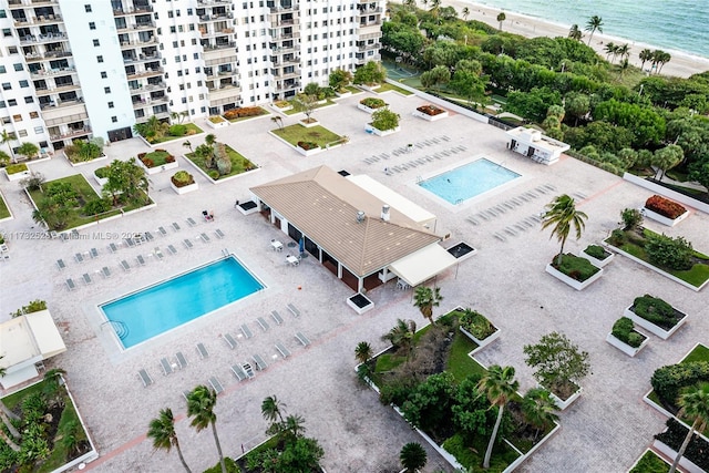 drone / aerial view featuring a beach view and a water view