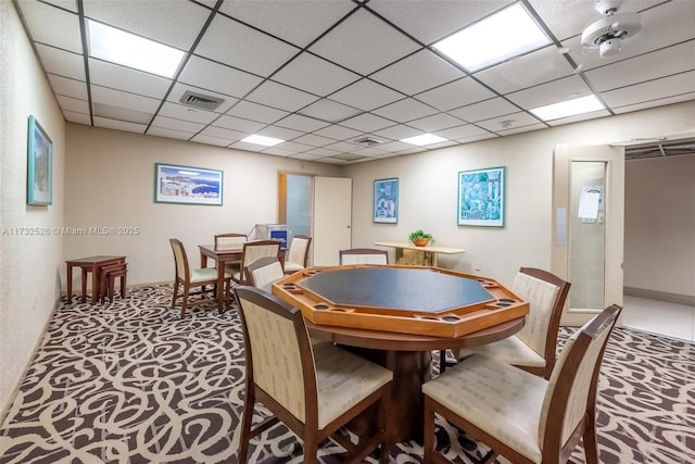 recreation room with carpet, a drop ceiling, and visible vents