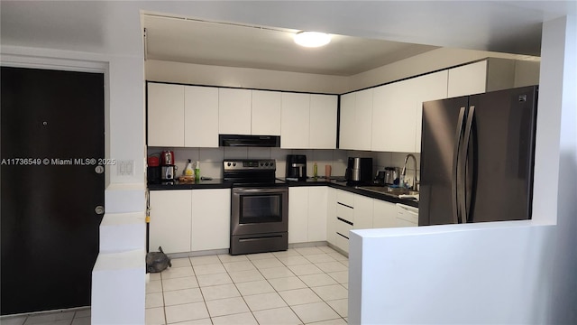 kitchen with sink, white cabinetry, stainless steel appliances, tasteful backsplash, and light tile patterned flooring