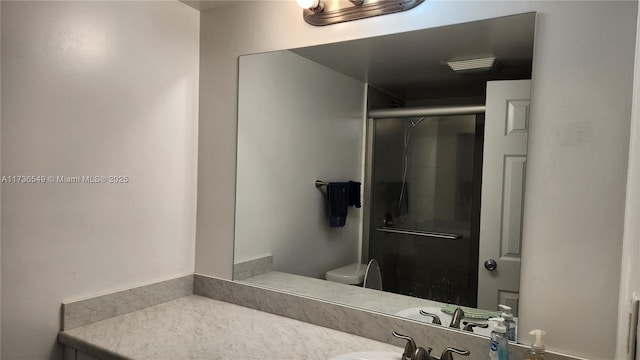 bathroom with vanity, toilet, and walk in shower