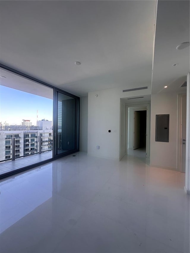 unfurnished room featuring electric panel and expansive windows