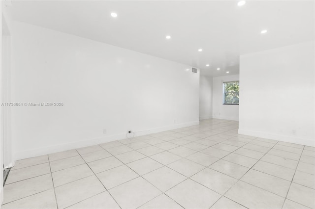 unfurnished room with baseboards, visible vents, and recessed lighting