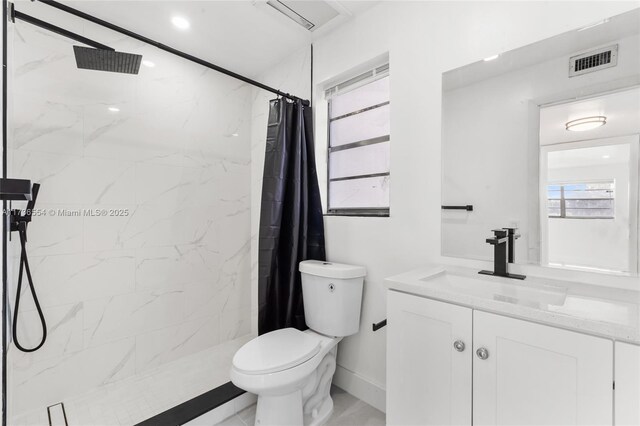 bathroom featuring curtained shower and toilet