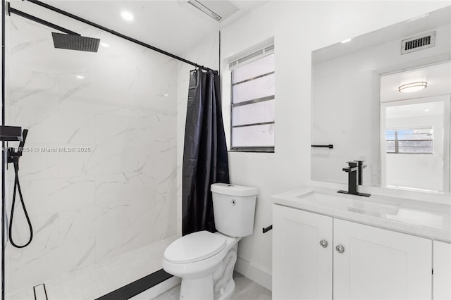 bathroom featuring toilet, a marble finish shower, visible vents, and vanity