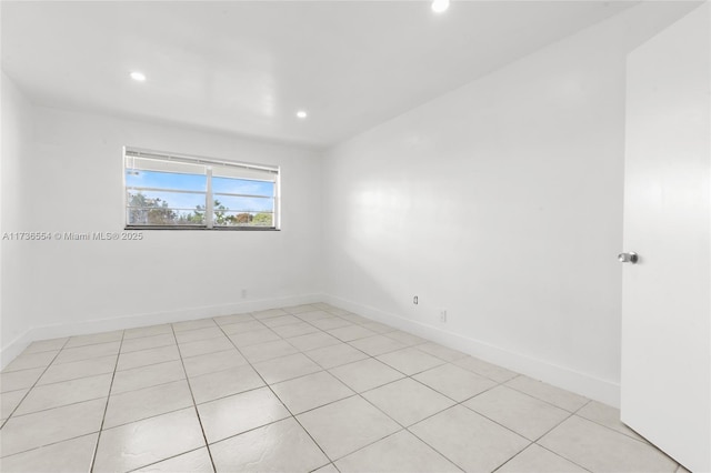 spare room with baseboards and recessed lighting