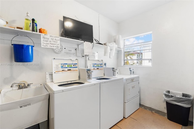 laundry area with washer and clothes dryer and a sink