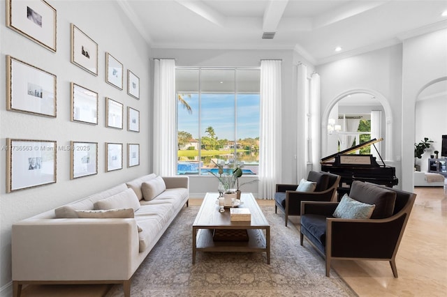 living room with beam ceiling, a wealth of natural light, and ornamental molding