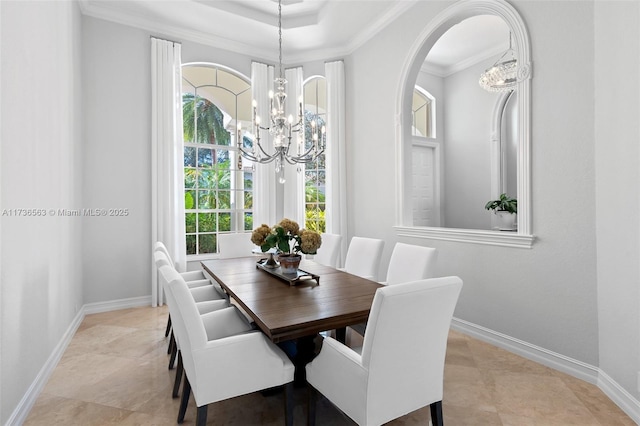 dining area with ornamental molding and a notable chandelier