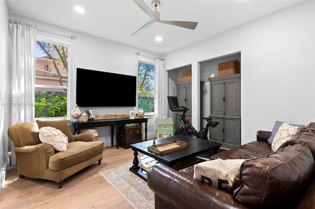 living room featuring ceiling fan and light hardwood / wood-style floors