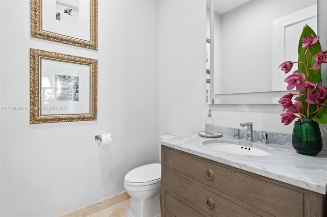 bathroom with vanity, tile patterned floors, and toilet