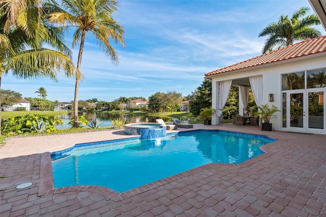 view of pool featuring french doors, an in ground hot tub, a water view, and a patio area