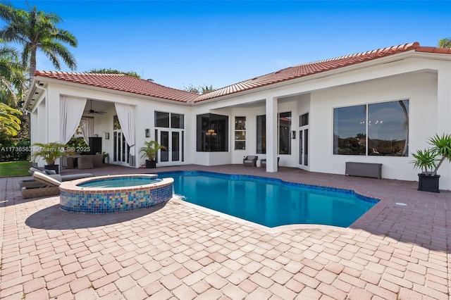 view of swimming pool with a patio, ceiling fan, and an in ground hot tub