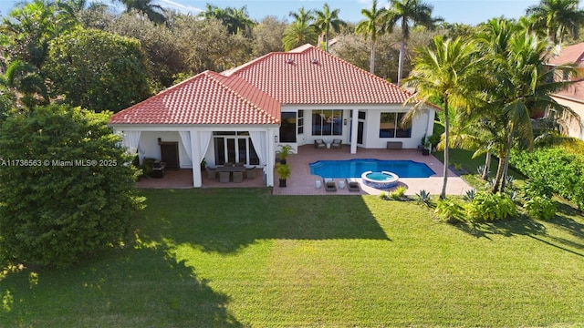 back of house with a yard and a patio