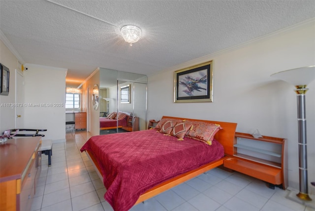 tiled bedroom featuring crown molding, a closet, and a textured ceiling