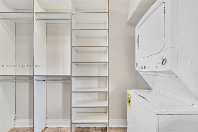 laundry area featuring stacked washer / drying machine