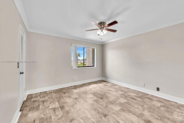 spare room featuring crown molding, ceiling fan, and light wood-type flooring