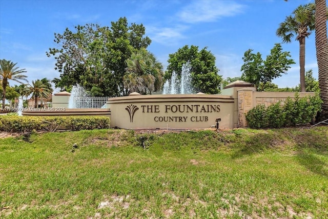 community / neighborhood sign with a lawn