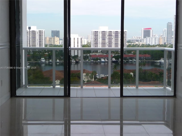 interior space featuring a water view and a wall of windows