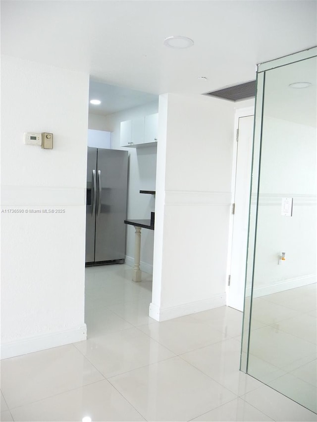 hallway featuring light tile patterned floors