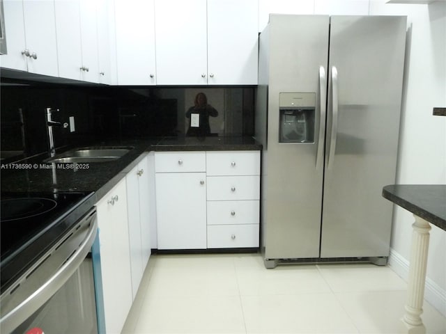 kitchen featuring white cabinetry, stainless steel appliances, sink, and tasteful backsplash