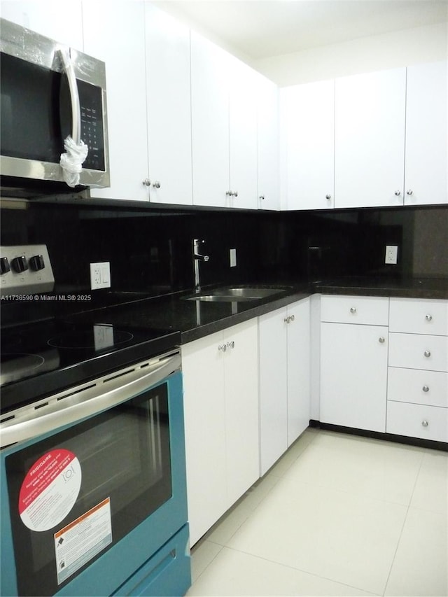 kitchen featuring tasteful backsplash, appliances with stainless steel finishes, and white cabinets