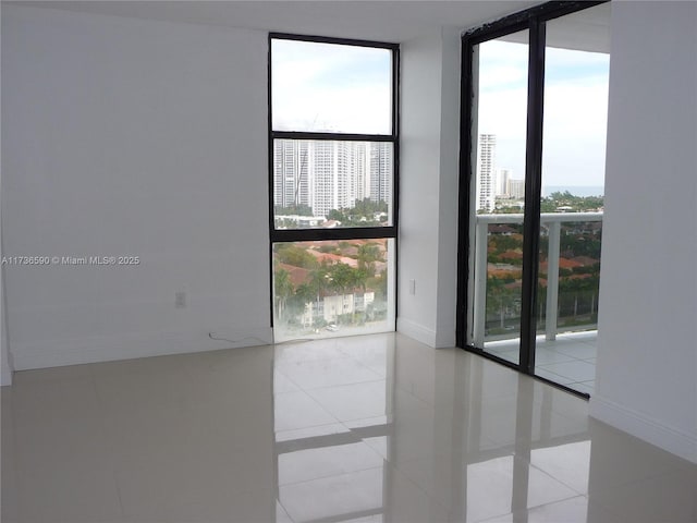 unfurnished room featuring expansive windows and light tile patterned floors