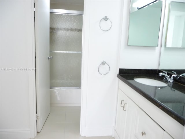 bathroom with vanity, tile patterned floors, and shower / bath combination with glass door