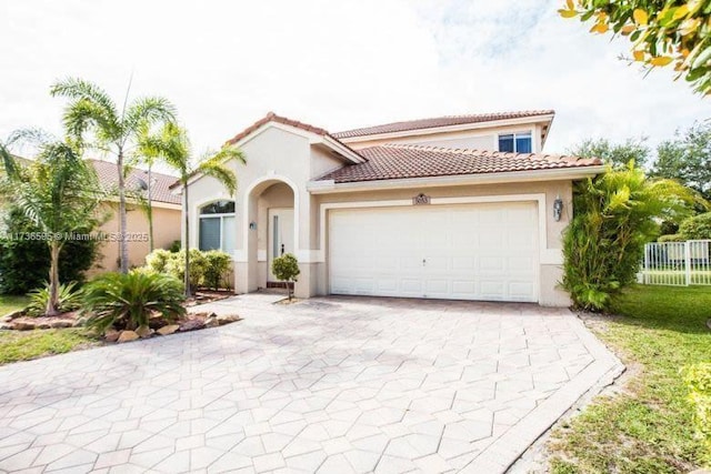 mediterranean / spanish house featuring a garage