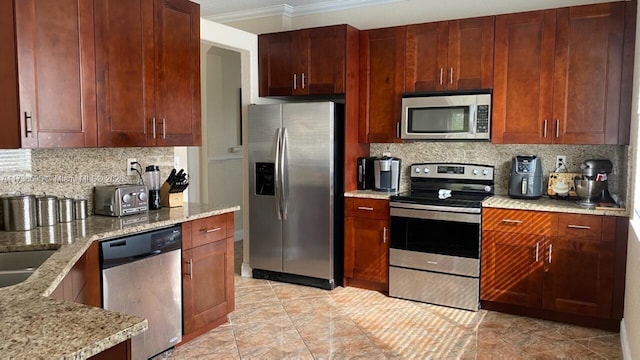 kitchen featuring backsplash, crown molding, light stone countertops, and appliances with stainless steel finishes