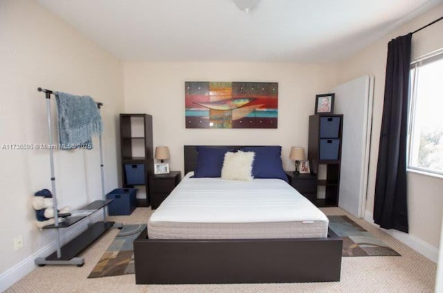 carpeted bedroom featuring multiple windows